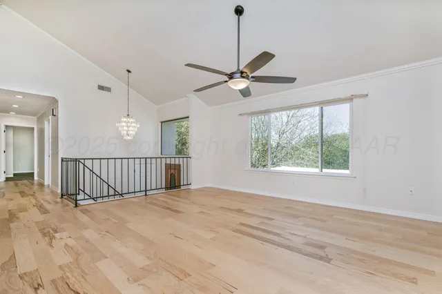 a view of a livingroom with a ceiling fan and window