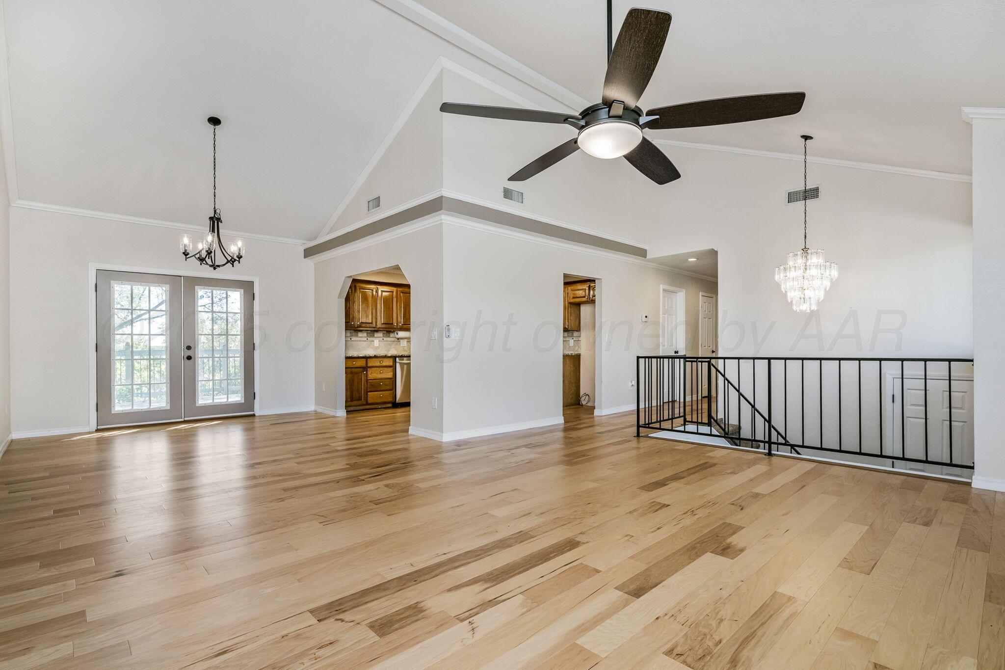 101 Mathis Drive Amarillo, TX 79118 - Photo 14 of 36 a view of an empty room with wooden floor and a ceiling fan