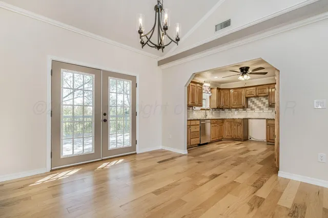 a view of a kitchen with a sink and wooden floor