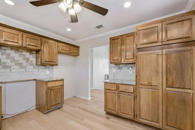 a kitchen with stainless steel appliances granite countertop a refrigerator and cabinets