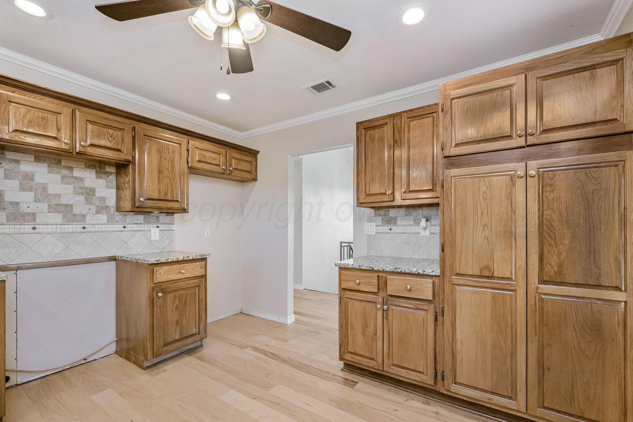 101 Mathis Drive Amarillo, TX 79118 - Photo 17 of 36 a kitchen with stainless steel appliances granite countertop a refrigerator and cabinets