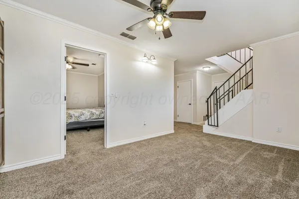 a view of an empty room with a fan
