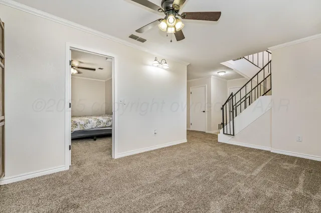 a view of an empty room with a fan