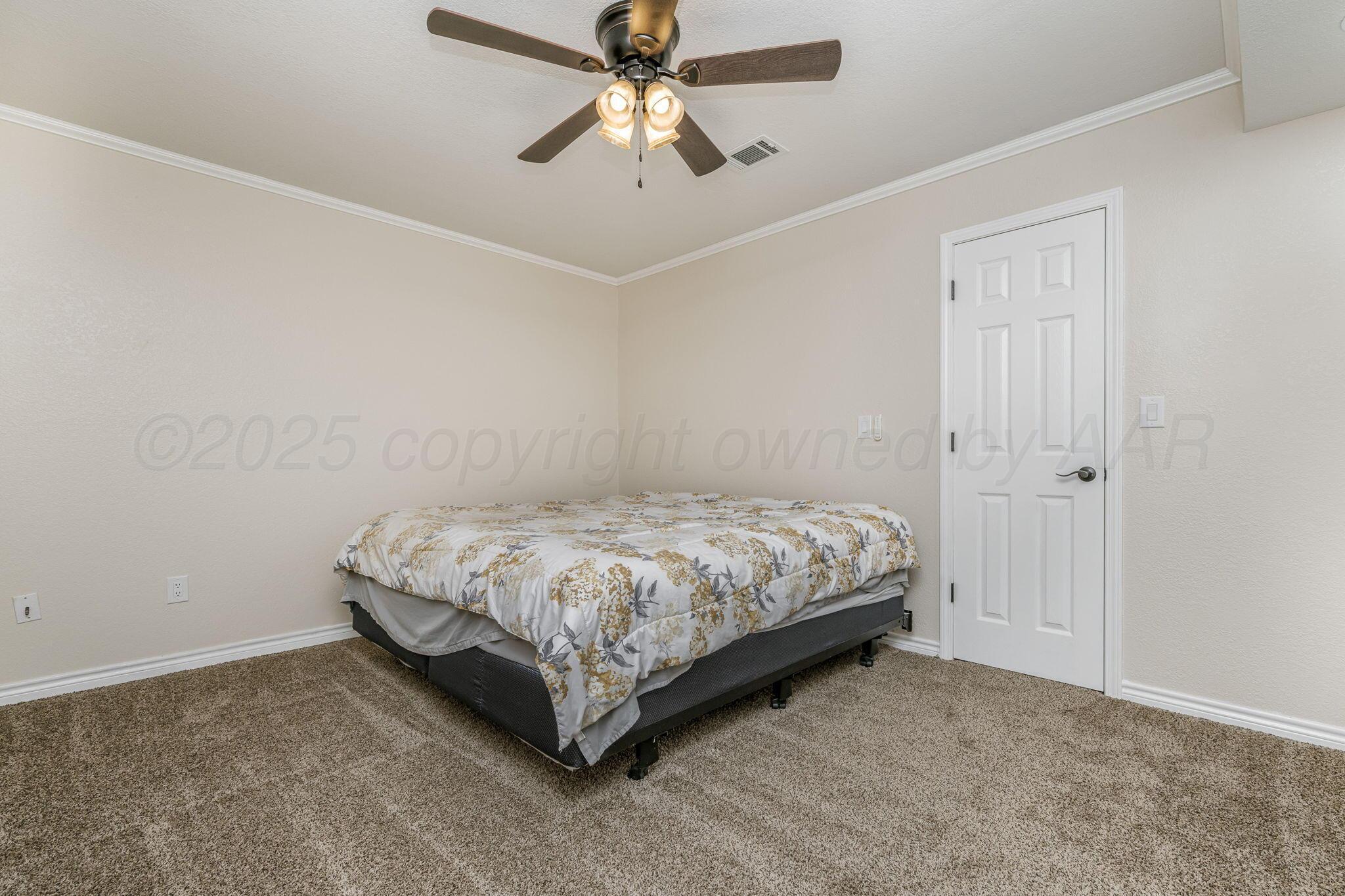 101 Mathis Drive Amarillo, TX 79118 - Photo 26 of 36 a bedroom with a bed and a ceiling fan