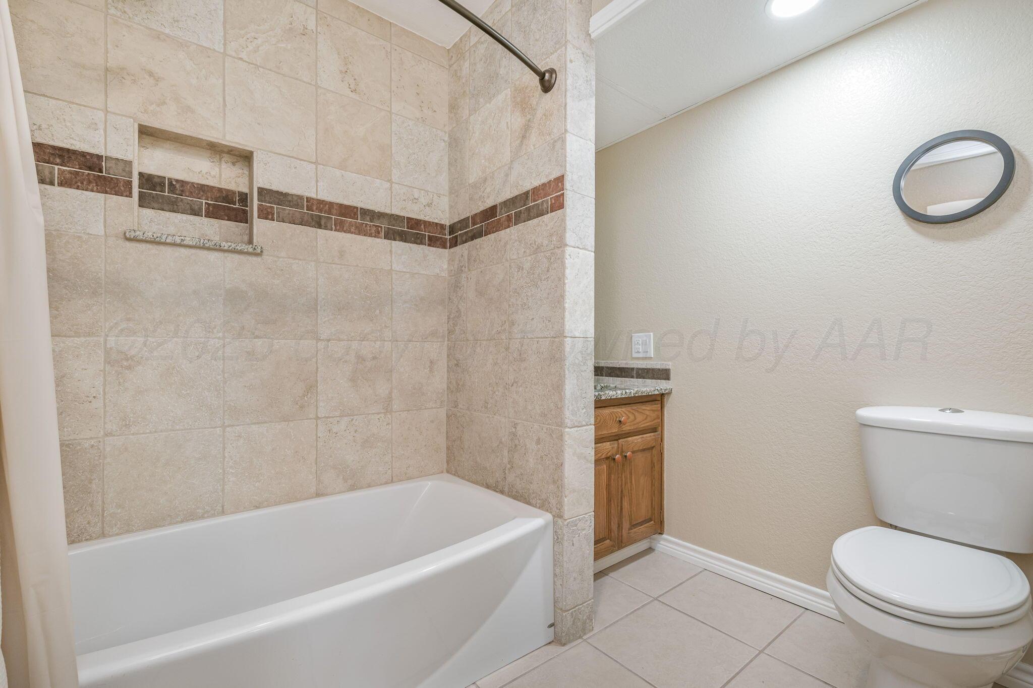 101 Mathis Drive Amarillo, TX 79118 - Photo 28 of 36 a bathroom with a toilet and a bathtub
