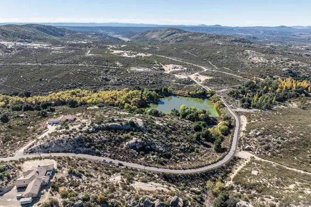 an aerial view of mountain with yard