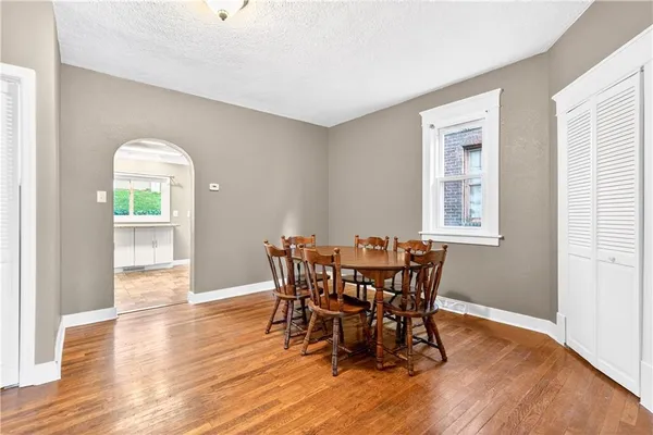 a view of a dining room with furniture and wooden floor
