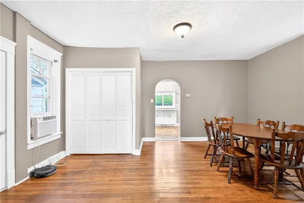 a view of a dining room with furniture and wooden floor