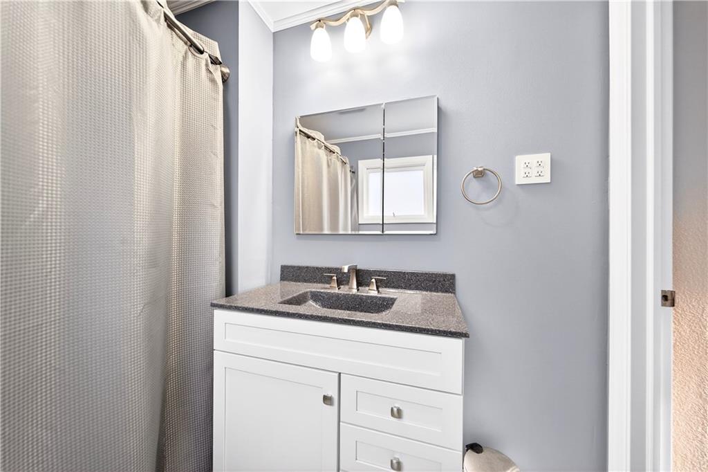 554 North Elm Street Butler, PA 16001 - Photo 21 of 31 a bathroom with a granite countertop sink and a mirror