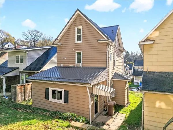 a view of house with backyard outdoor seating and barbeque oven