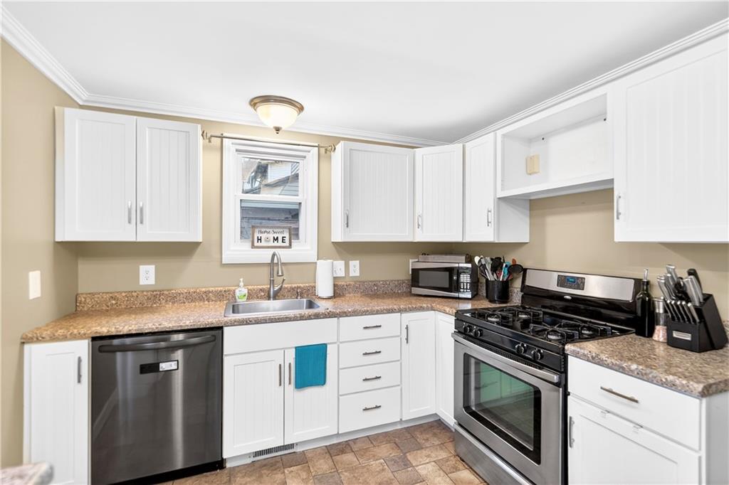 554 North Elm Street Butler, PA 16001 - Photo 9 of 31 a kitchen with cabinets stainless steel appliances and a sink