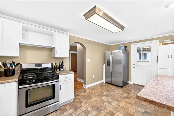 a kitchen with stainless steel appliances granite countertop a stove a refrigerator and a stove