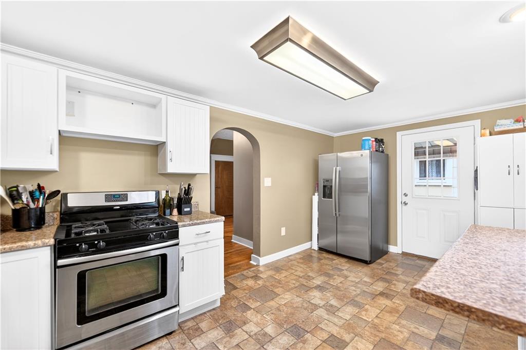 554 North Elm Street Butler, PA 16001 - Photo 10 of 31 a kitchen with stainless steel appliances granite countertop a stove a refrigerator and a stove