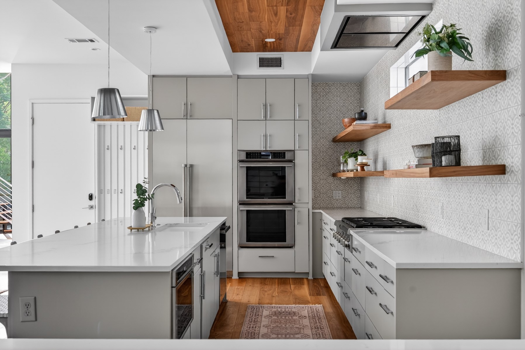 a kitchen with stainless steel appliances a stove a sink and a refrigerator