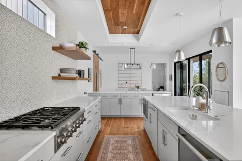 a kitchen with a sink stove and cabinets