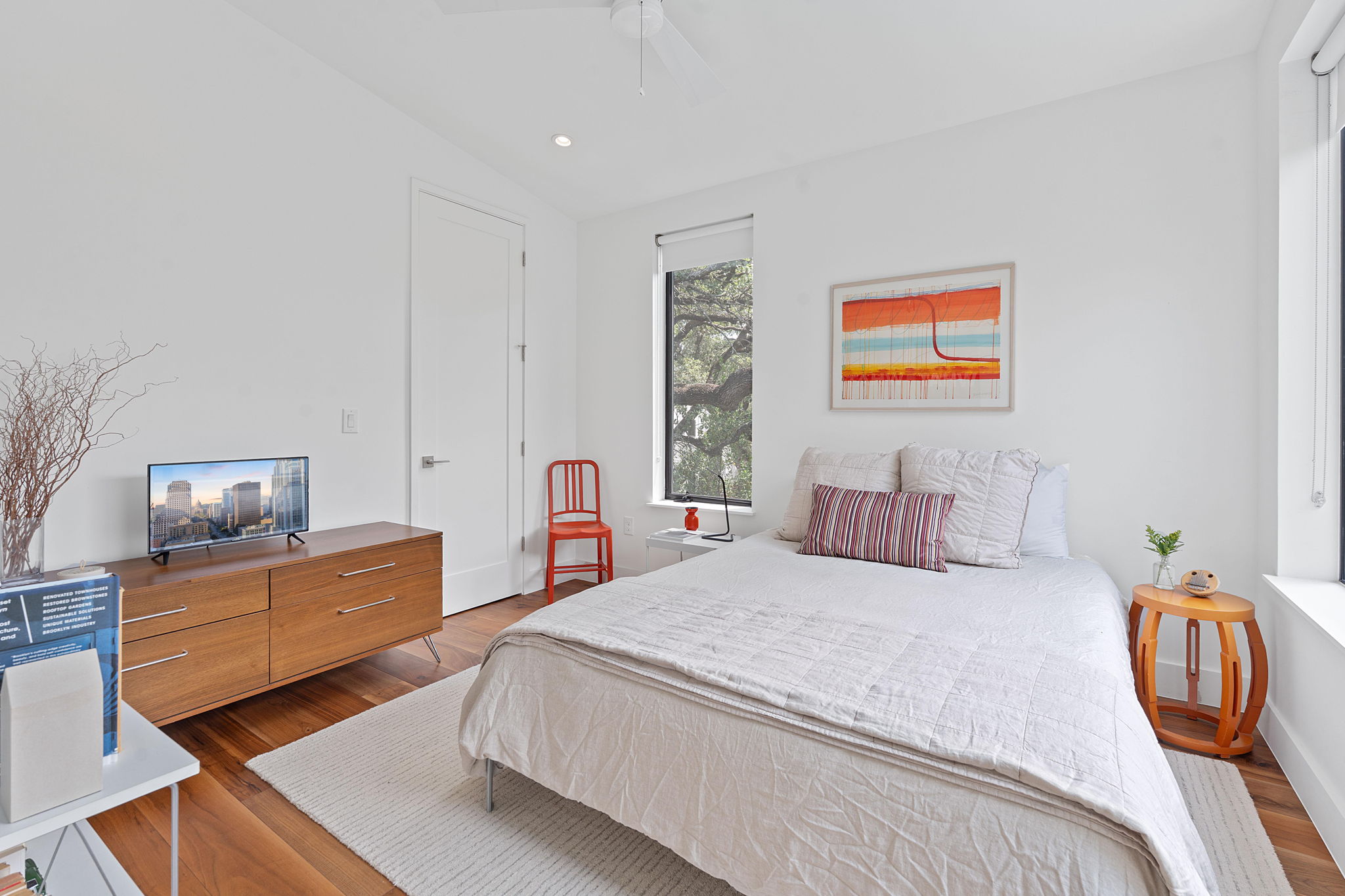 1605 Chelsea Lane, Unit 1 Austin, TX 78704 - Photo 32 of 39 a bedroom with a bed and wooden floor