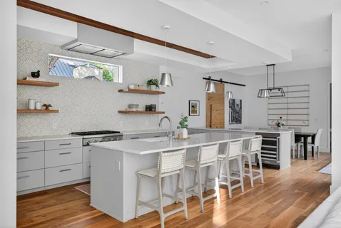 a kitchen with a table chairs stove and cabinets