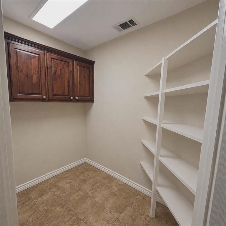 14752 Ranch Road Forney, TX 75126 - Photo 14 of 40 Built-in shelving and cabinetry provide ample storage that may also be used as pantry.-This photo was taken before family moved in