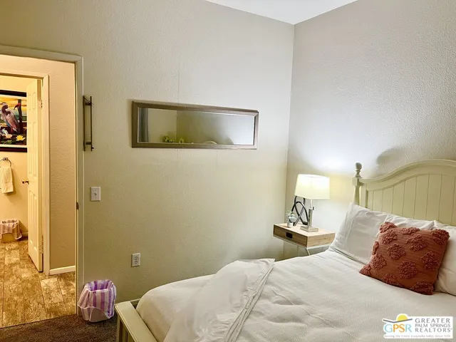 a view of a hallway with wooden floor and closet