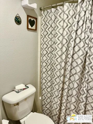 a bedroom with a bed and a table in it