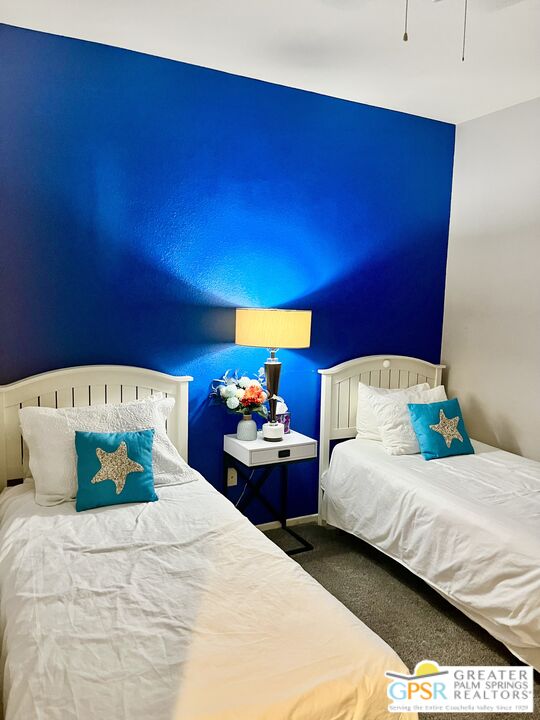 83680 Jaderock Road Coachella, CA 92236 - Photo 17 of 41 a bedroom with a bed and a potted plant