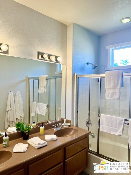83680 Jaderock Road Coachella, CA 92236 - Photo 34 of 41 a bathroom with a granite countertop sink and a mirror