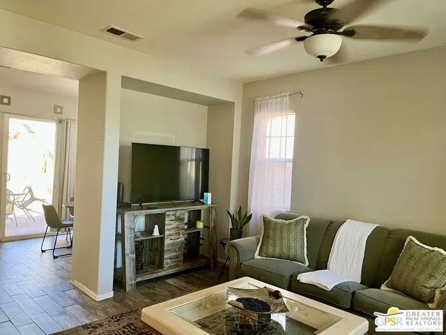 a bedroom with a bed and a lamp on the dresser