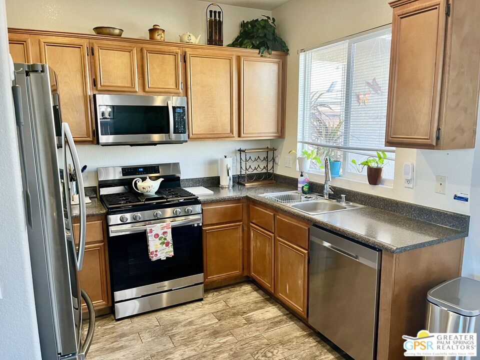 83680 Jaderock Road Coachella, CA 92236 - Photo 6 of 41 a kitchen with stainless steel appliances granite countertop a sink stove and microwave