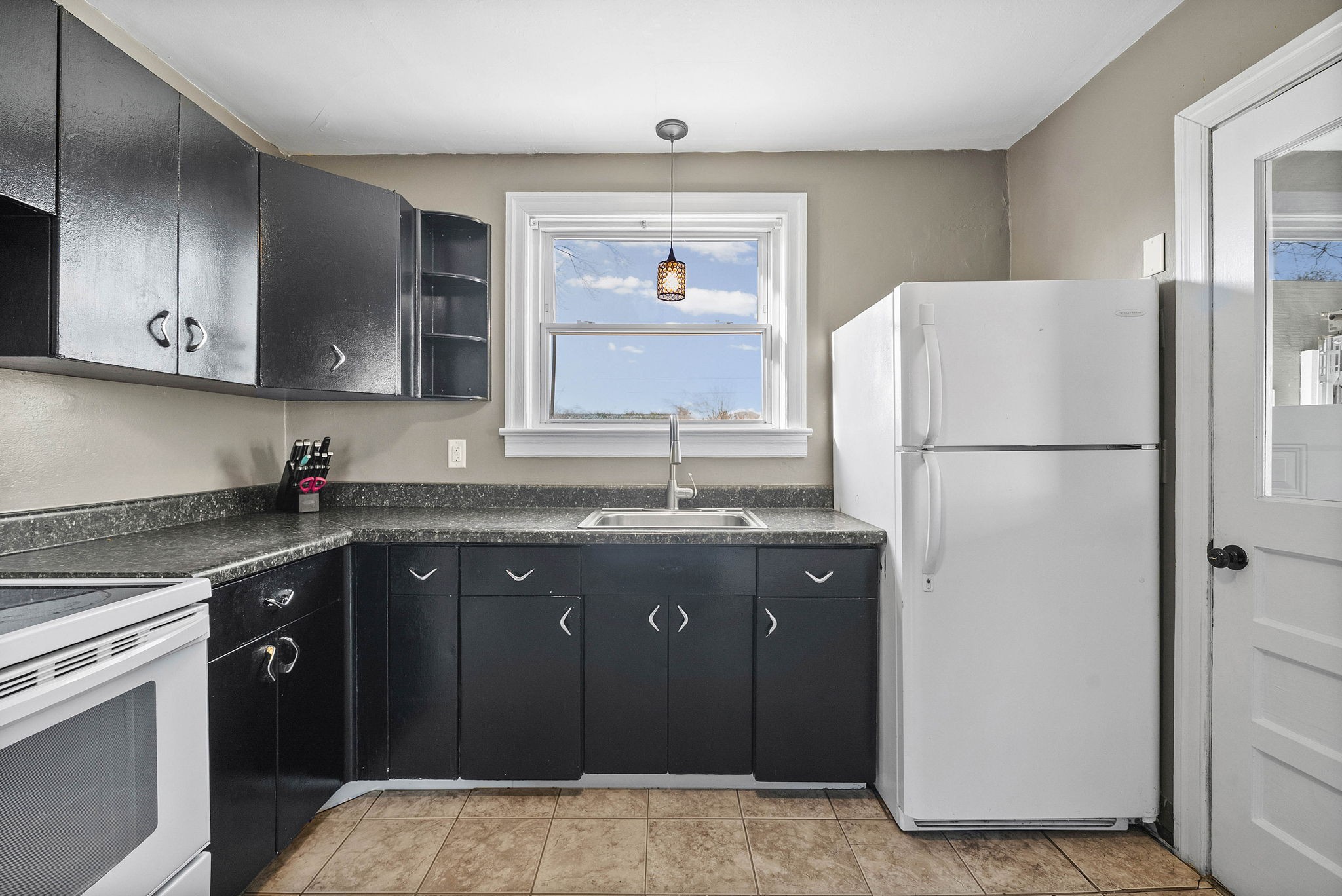 1673 Valley Road Clarksville, TN 37043 - Photo 12 of 33 a kitchen with granite countertop a refrigerator and a sink