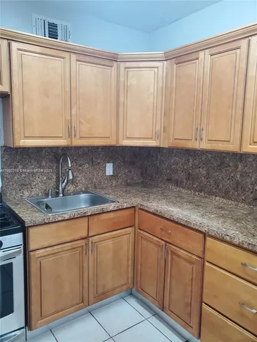 a kitchen with stainless steel appliances granite countertop a sink and a cabinets