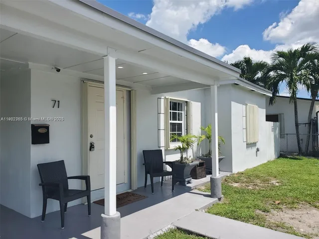 a view of backyard of a house with yard and outdoor seating