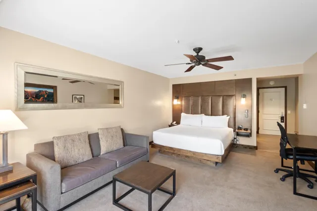 a living room with couches a fireplace and a flat screen tv