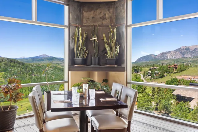 a view of a chairs and table in the balcony