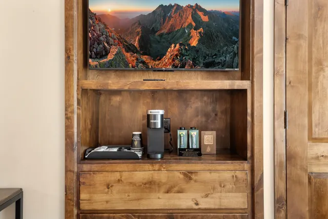 a view of a living room with a painting on the wall