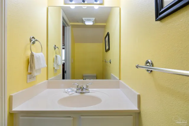 a view of a dining room with furniture a chandelier and wooden floor