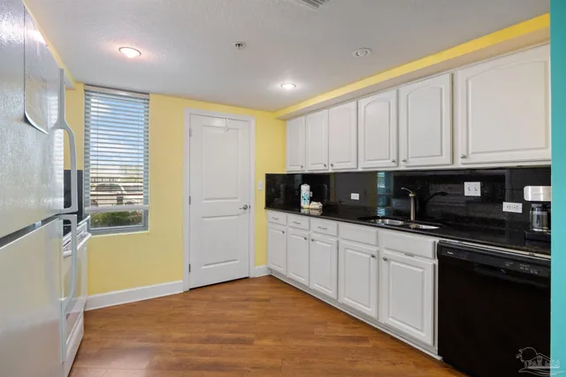 a kitchen with stainless steel appliances a refrigerator sink and microwave