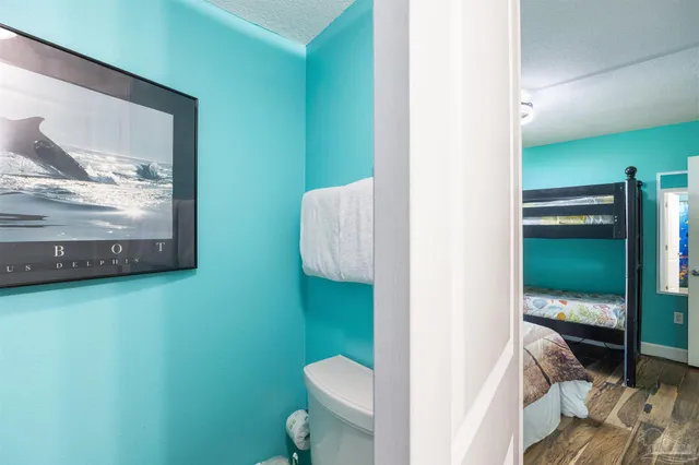 a bedroom with a bed and a painting on the wall