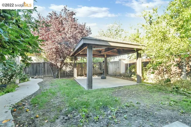 a view of a porch with furniture and next to a yard