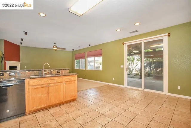 a view of house with a yard and potted plants