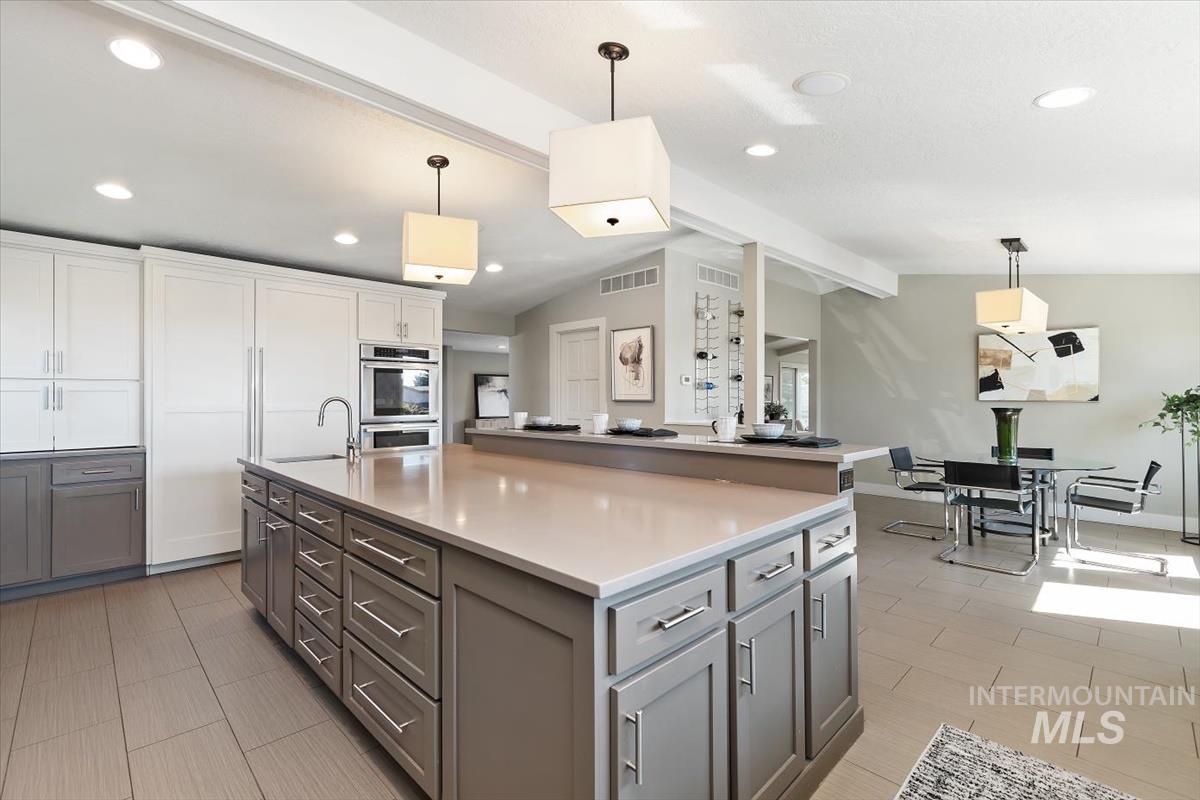 709 East Braemere Road Boise, ID 83702 - Photo 10 of 50 Spacious kitchen featuring an expansive center island with countertop, stainless steel appliances, recessed lighting, and wood-finish flooring