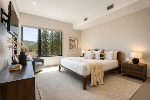 a spacious bedroom with two beds and large windows