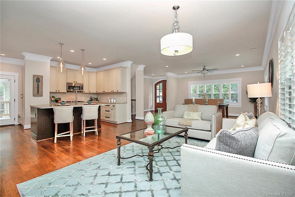 132 Scofield Road Charlotte, NC 28209 - Photo 12 of 44 a living room with furniture kitchen and a chandelier