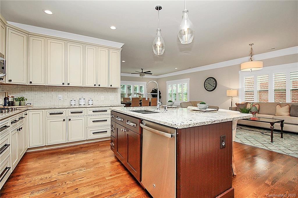 132 Scofield Road Charlotte, NC 28209 - Photo 13 of 44 a kitchen with kitchen island granite countertop a stove and a view of living room