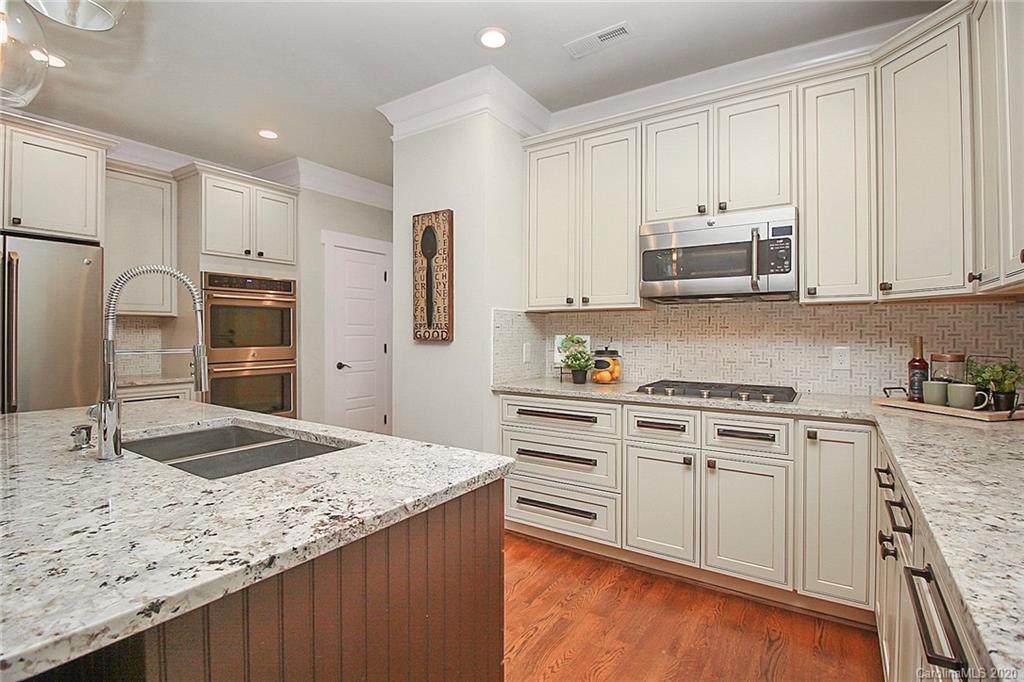 132 Scofield Road Charlotte, NC 28209 - Photo 17 of 44 a kitchen with stainless steel appliances granite countertop a stove a sink and a refrigerator