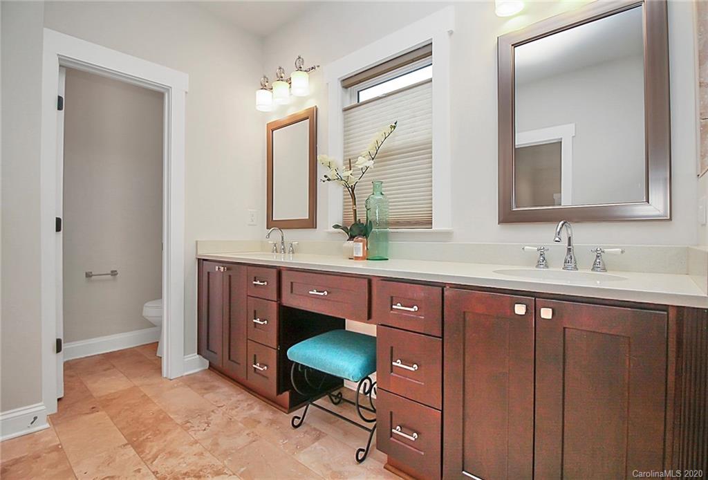 132 Scofield Road Charlotte, NC 28209 - Photo 22 of 44 a spacious bathroom with a double vanity sink and a mirror