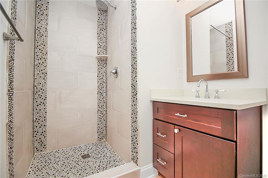 132 Scofield Road Charlotte, NC 28209 - Photo 25 of 44 a bathroom with a sink a mirror and a shower