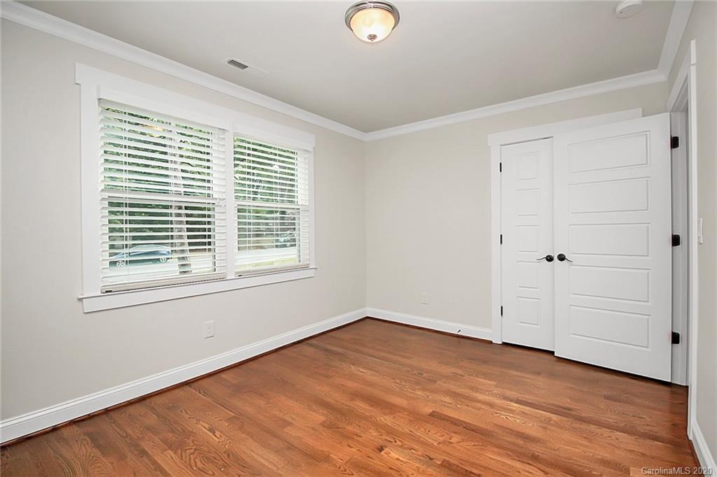 132 Scofield Road Charlotte, NC 28209 - Photo 27 of 44 a view of empty room with wooden floor and fan