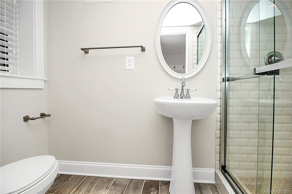 132 Scofield Road Charlotte, NC 28209 - Photo 32 of 44 a bathroom with a sink a toilet and a mirror