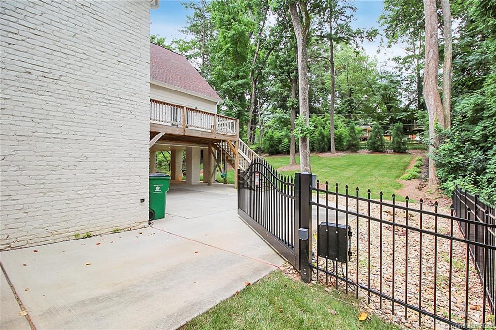 132 Scofield Road Charlotte, NC 28209 - Photo 38 of 44 a view of a garden with a brick wall