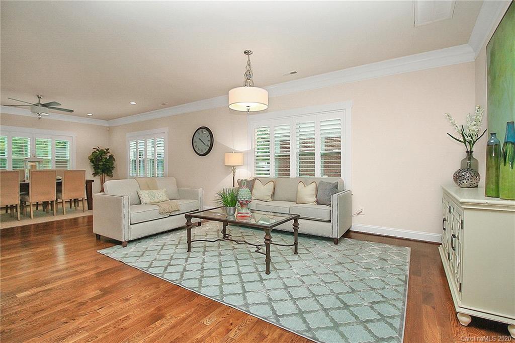 132 Scofield Road Charlotte, NC 28209 - Photo 10 of 44 a living room with furniture dining table wooden floor and a chandelier